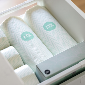 An open drawer filled with Save Tree's bamboo paper towels, organized and ready for use in a bathroom setting