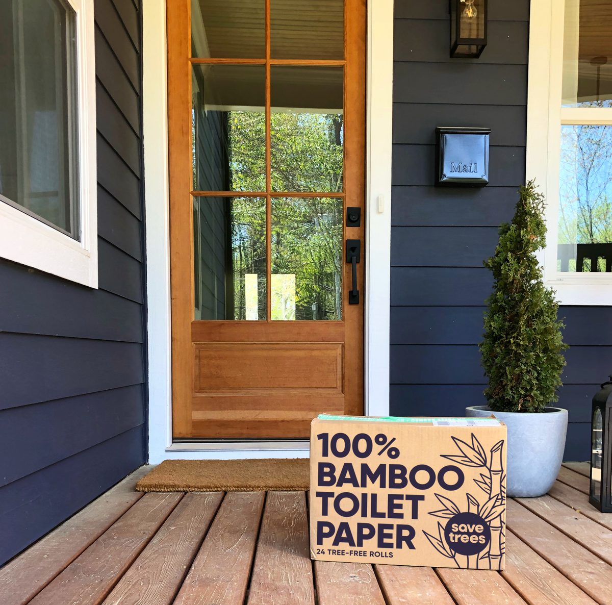 Cloud Paper plastic-free box with bamboo toilet paper on a house porch